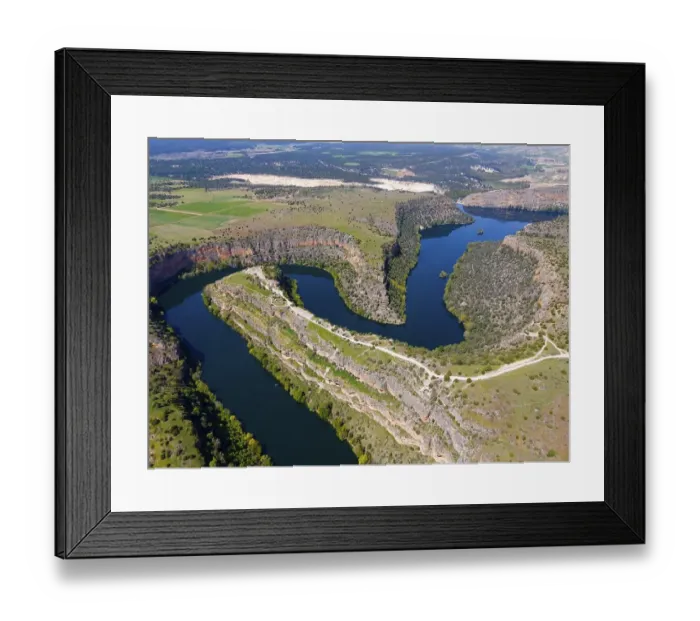 Framed Print : Picturesque river running through dramatic gorges and surrounded by dense vegetation and green fields Framed Print : Picturesque river running through dramatic gorges and surrounded by dense vegetation and green fields