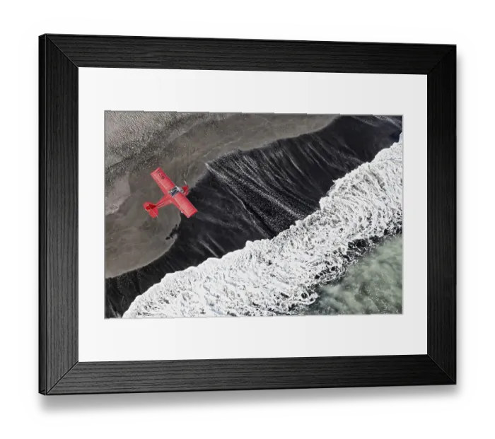 Framed Print : Aerial view, a red single-engine lightweight airplane flying over the waves of the North Atlantic Framed Print : Aerial view, a red single-engine lightweight airplane flying over the waves of the North Atlantic