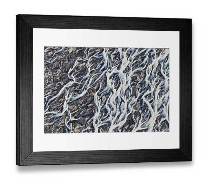 Framed Print : Aerial view, a red single-engine lightweight airplane flying over the flow structures of the melt water branching out