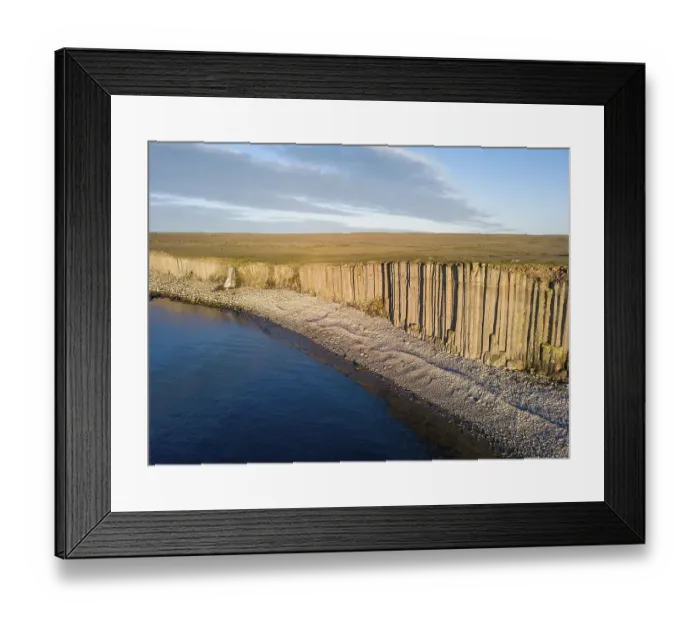 Framed Print : Basalt columns in the evening light at the beach with waterfall