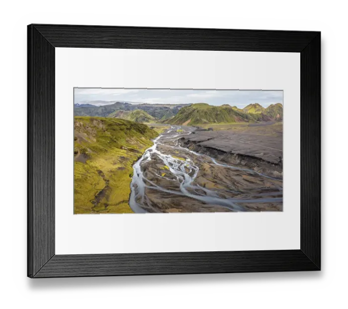 Framed Print : River with fanned out branches through black lava sand