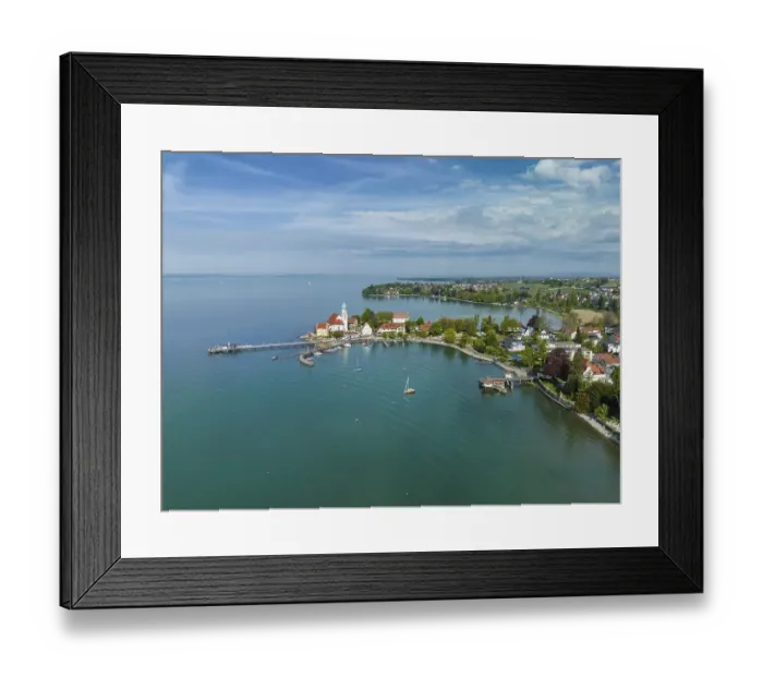 Framed Print : Aerial view of the moated castle peninsula on Lake Constance with the baroque church of St Framed Print : Aerial view of the moated castle peninsula on Lake Constance with the baroque church of St