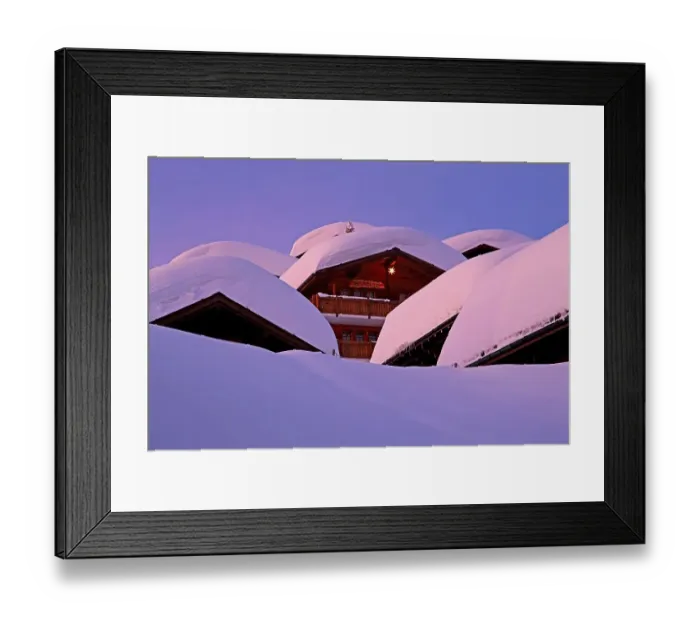 Framed Print : Chalets with deep snow in the village at dusk