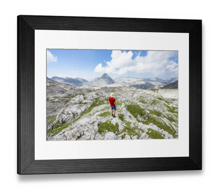 Framed Print : Hiker looks into the distance, landscape of washed out karst stone rocks Framed Print : Hiker looks into the distance, landscape of washed out karst stone rocks