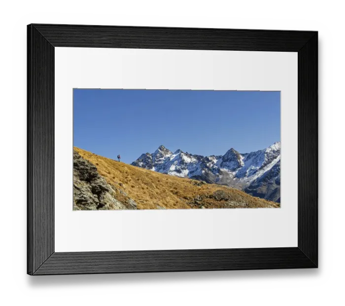 Framed Print : Mountaineer on ridge with snow-covered South Tyrolean mountains in autumnal mountain landscape Framed Print : Mountaineer on ridge with snow-covered South Tyrolean mountains in autumnal mountain landscape