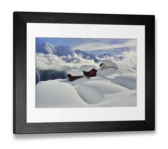 Framed Print : Maria zum Schnee chapel with snow-covered log cabins