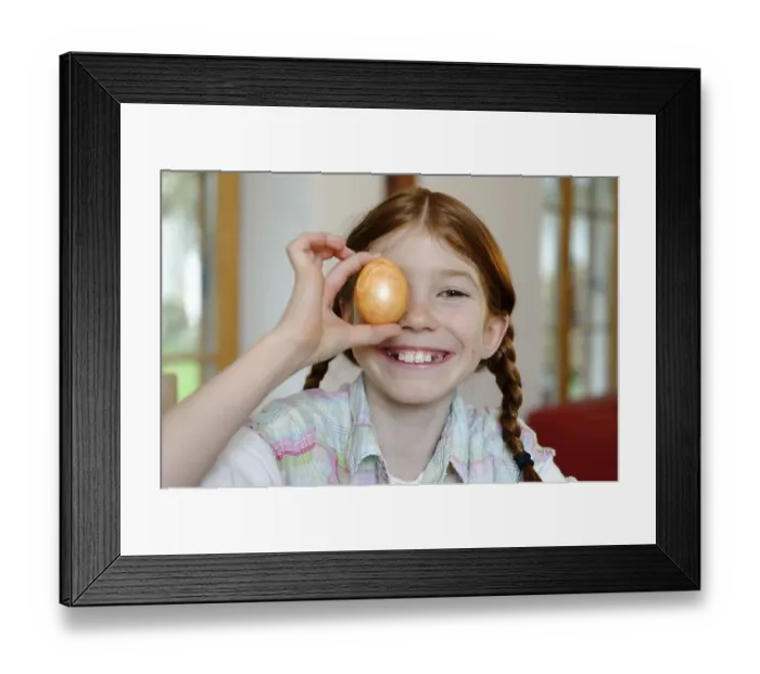 Framed Print : Child, girl holding a coloured Easter egg Framed Print : Child, girl holding a coloured Easter egg