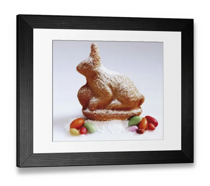 Framed Print : Easter bunny made of sponge cake sitting on icing sugar with Easter sweets Framed Print : Easter bunny made of sponge cake sitting on icing sugar with Easter sweets
