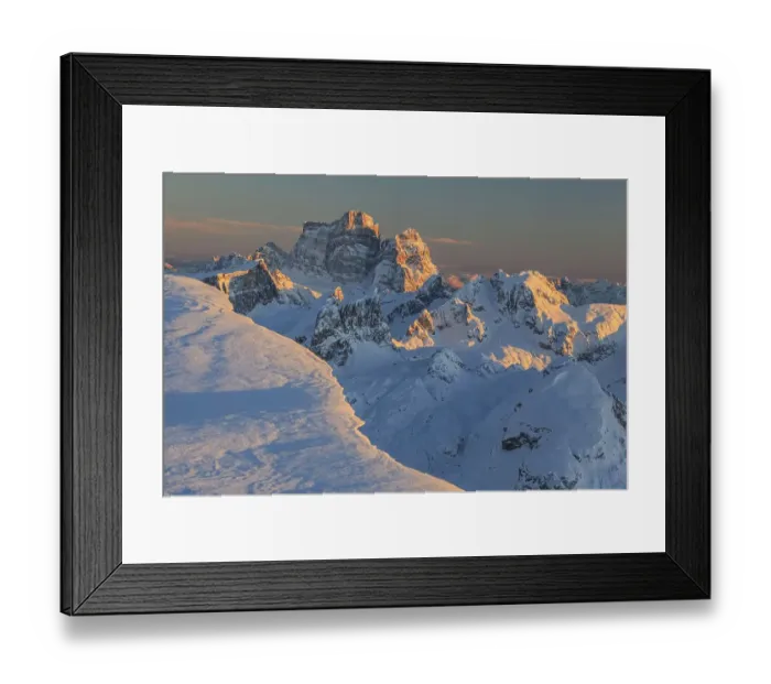 Framed Print : Mountain peak in the snow at sunset