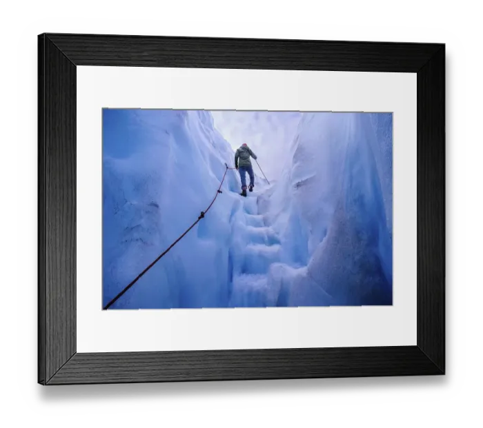 Framed Print : Woman walking steps out of a ice cave in Fox Glacier Framed Print : Woman walking steps out of a ice cave in Fox Glacier