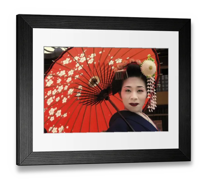 Framed Print : A Maiko, a trainee Geisha, carrying a red sun parasol or umbrella Framed Print : A Maiko, a trainee Geisha, carrying a red sun parasol or umbrella