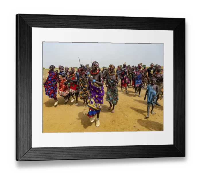 Framed Print : Traditional dressed women of the Jiye tribe dancing and singing