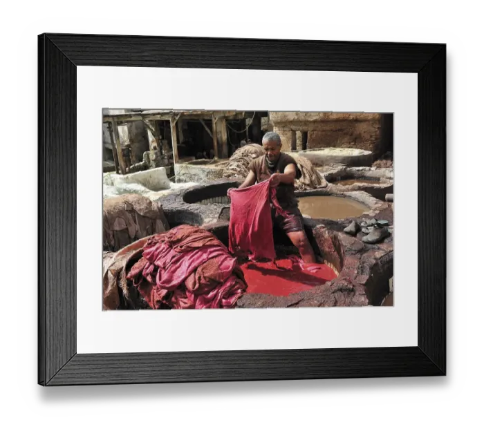 Framed Print : Worker standing in a vat of red paint to dye leather in a tannery
