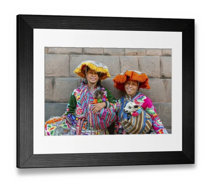 Framed Print : Two Inca woman in traditional traditional costume with lambs in front of an Inca wall