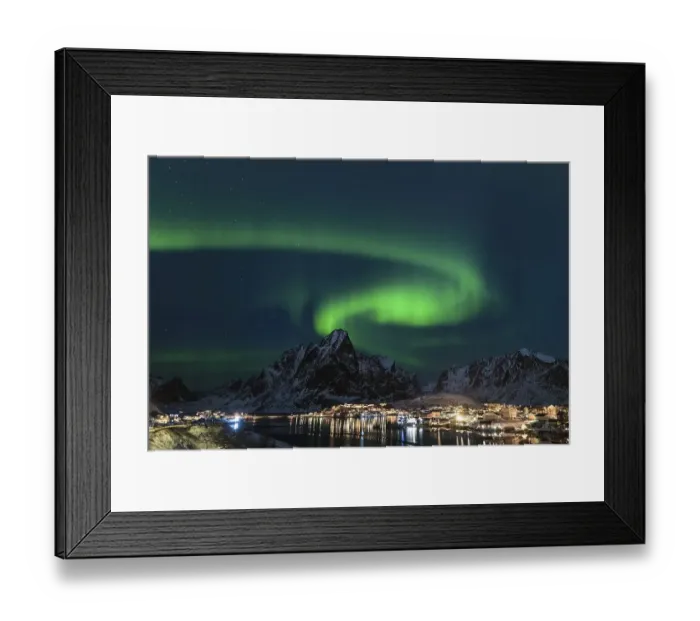 Framed Print : Dancing green polar lights over the village Reine on the Lofoten islands in Norway at night in winter with snow capped Framed Print : Dancing green polar lights over the village Reine on the Lofoten islands in Norway at night in winter with snow capped