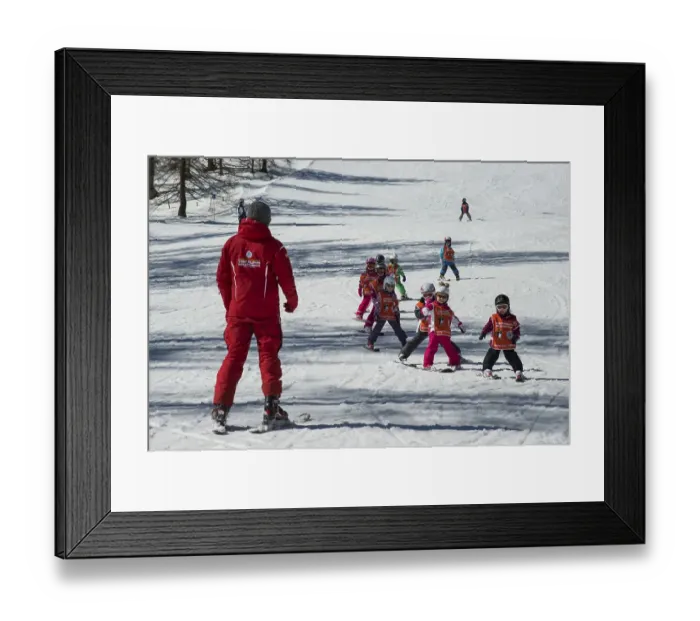 Framed Print : Children ski lessons with instructor on the piste