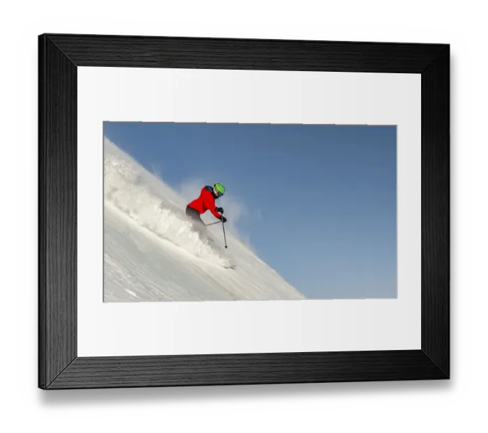 Framed Print : Female skier on the ski slope at steep slope Framed Print : Female skier on the ski slope at steep slope