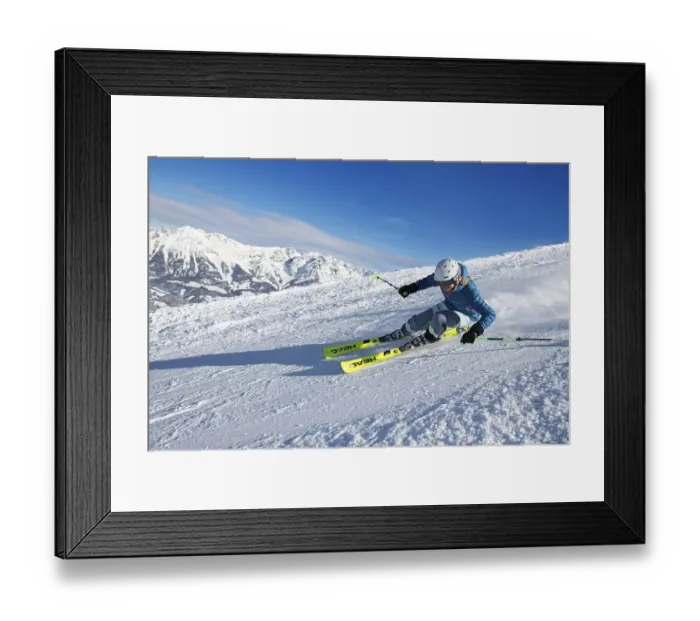 Framed Print : Young female skier with sporty style of skiing at the descent from the Hohe Salve