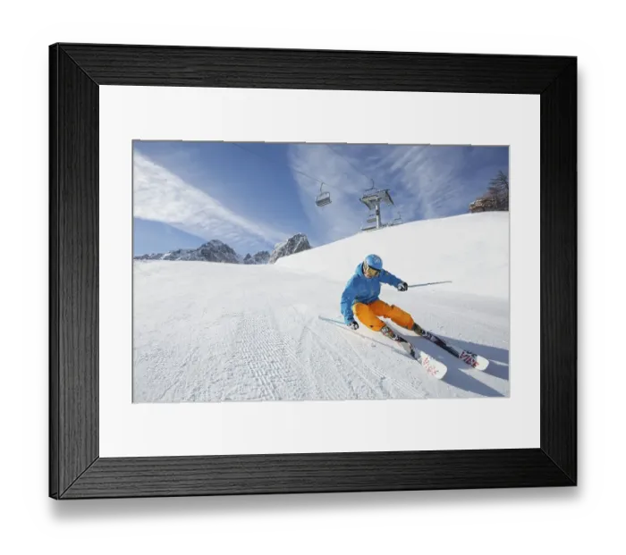 Framed Print : Skier with a helmet skiing down a slope
