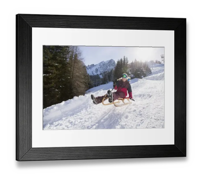 Framed Print : Young woman riding on a sledge