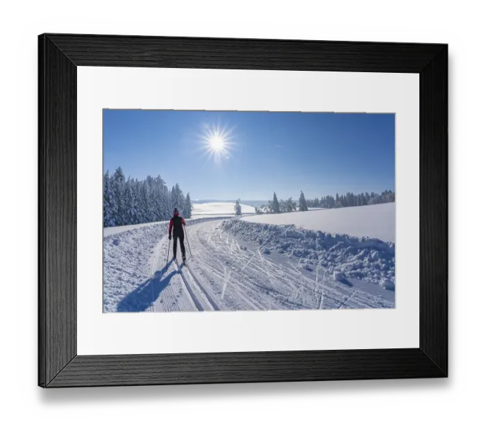 Framed Print : Pretty active senior woman cross-country skiing in freshly fallen powder snow in the Allgaeu Alps near Immenstadt