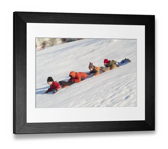 Framed Print : Chain of children sliding on their bellies downhill