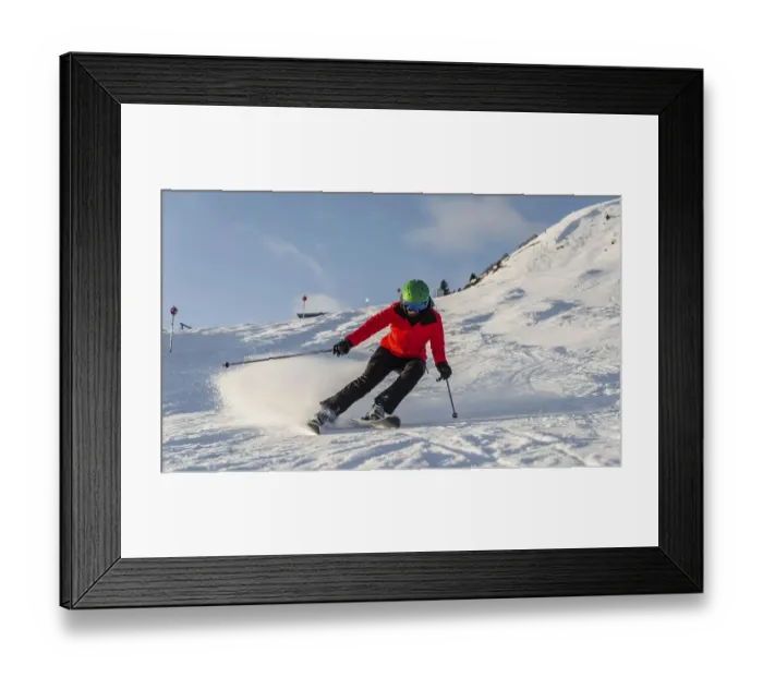 Framed Print : Female skier skiing in short turns
