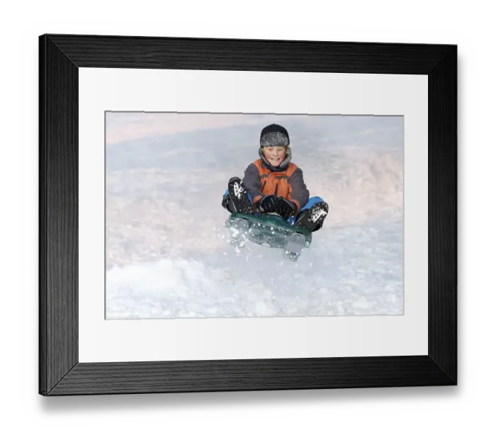 Framed Print : Boy jumping with a sledge
