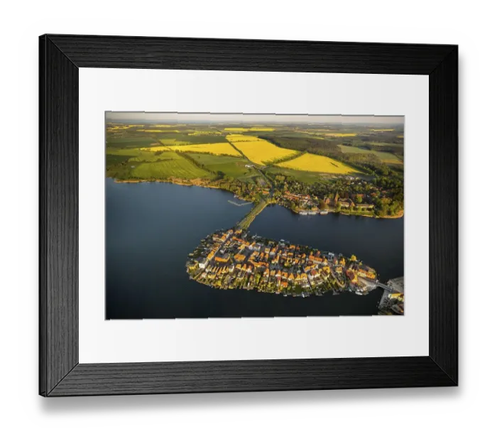 Framed Print : Aerial view, Malchow with Malchower See lake and the island with the historic centre and its old market square Framed Print : Aerial view, Malchow with Malchower See lake and the island with the historic centre and its old market square