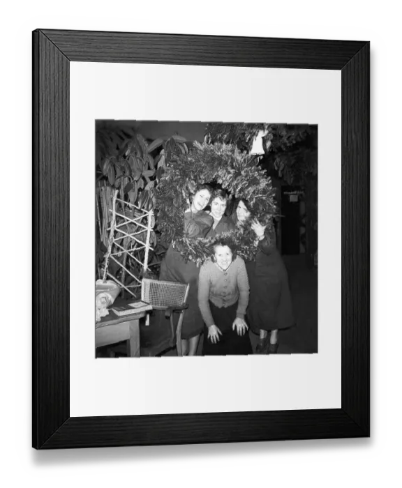 Framed Print : Saleswomen of a flower shop posing in front of a large Advent wreath