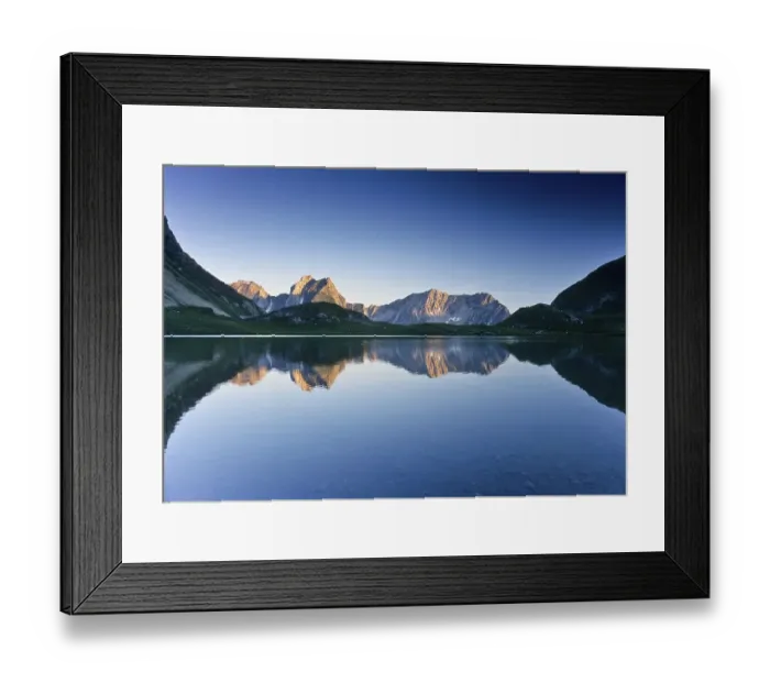 Framed Print : Mountains reflected in Lake Seewiessee near Memminger Huette alpine hut
