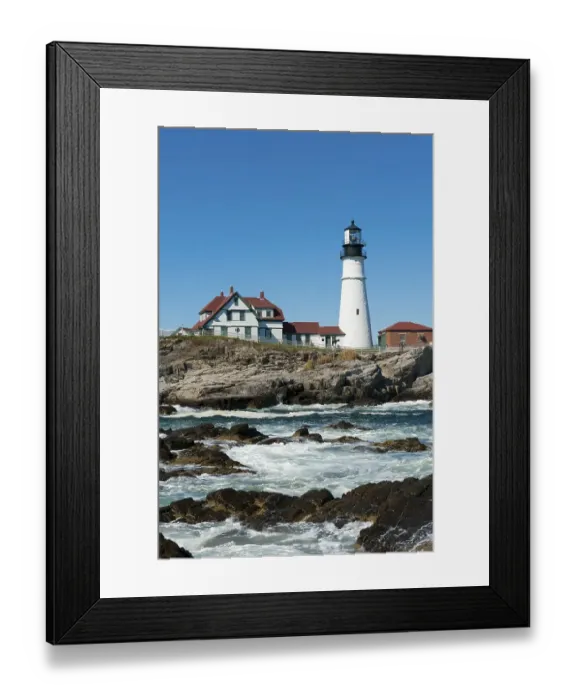 Framed Print : Lighthouse, waves breaking on rocks