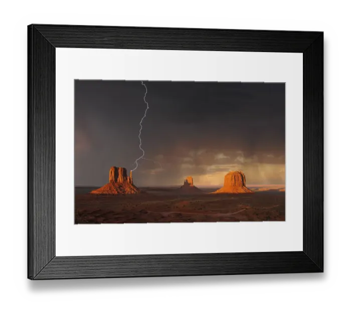 Framed Print : Lightning strikes during a thunderstorm in the evening light