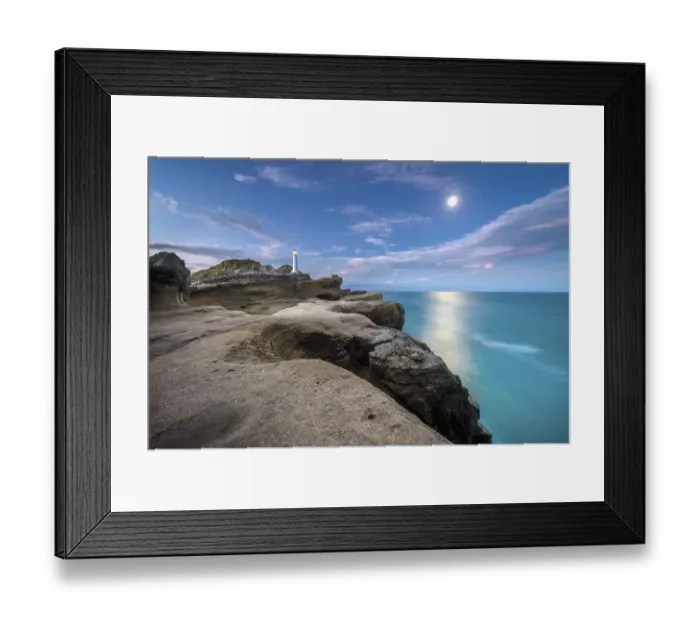 Framed Print : Lighthouse at full moon on the cliffs of lava rock at Castlepoint