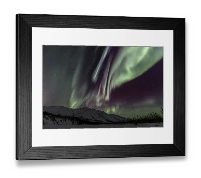 Framed Print : Green, yellow and purple northern lights (aurora borealis) over snowy mountains Framed Print : Green, yellow and purple northern lights (aurora borealis) over snowy mountains
