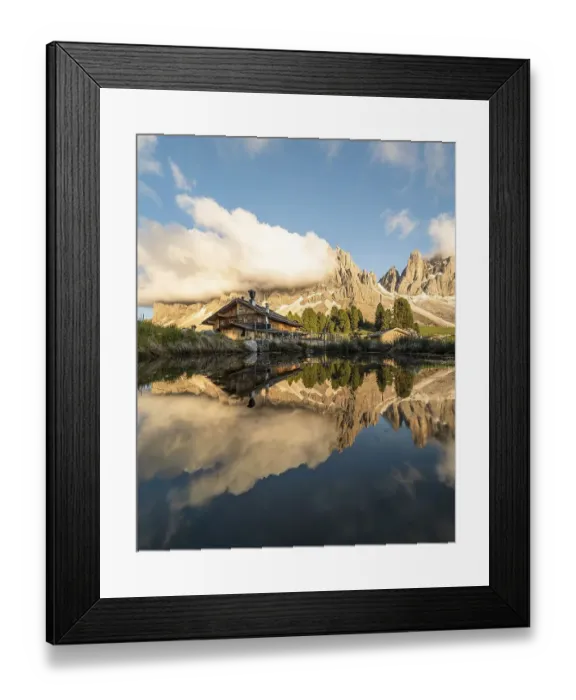 Framed Print : Reflection from the Furchetta mountain and the Geisler Alm hut in a pond near the Geisler Alm at sunset