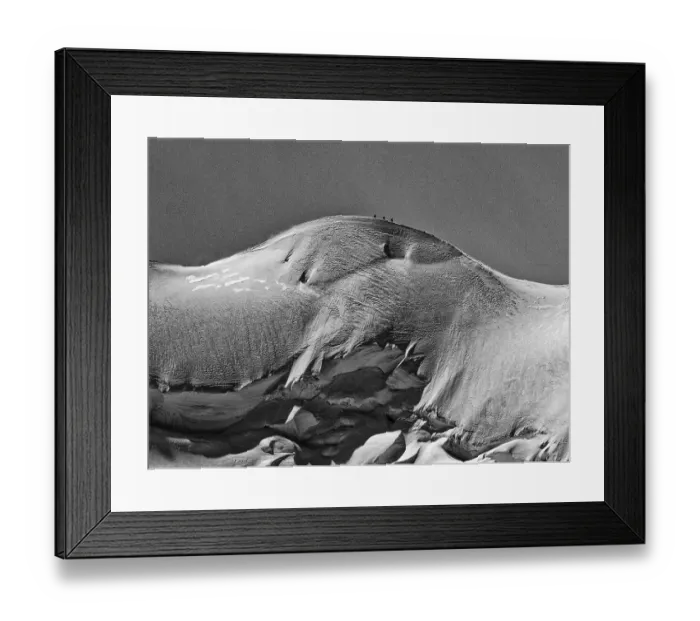 Framed Print : A black and white shot of snow-covered mountains with a tranquil atmosphere