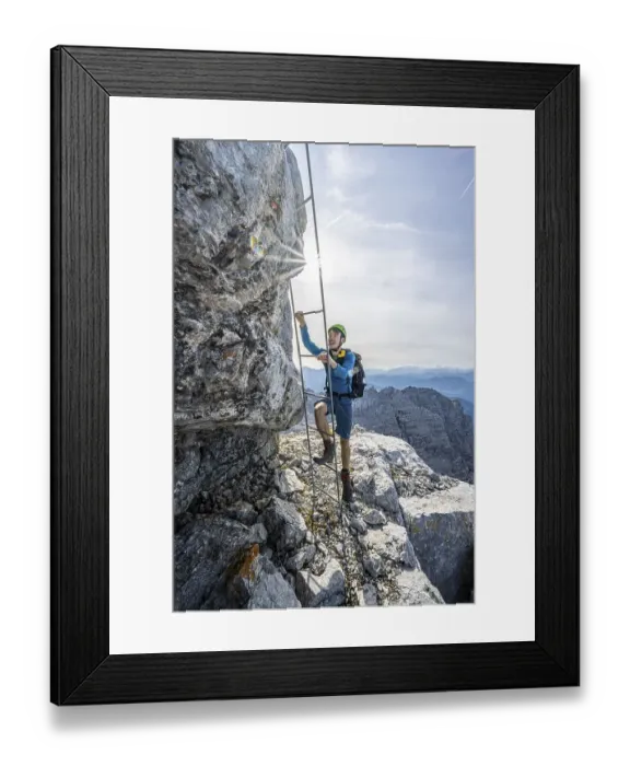 Framed Print : Hiker in a secured path, climbing a ladder