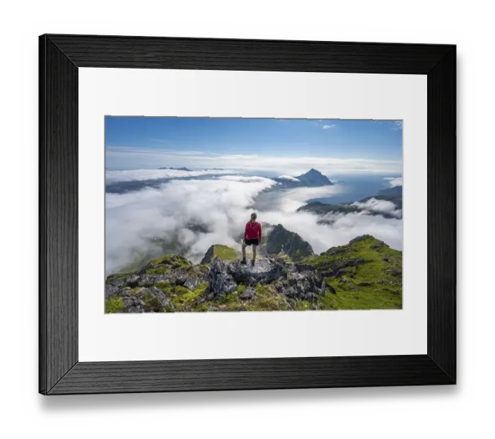 Framed Print : Hiker looking over mountain landscape in clouds Framed Print : Hiker looking over mountain landscape in clouds