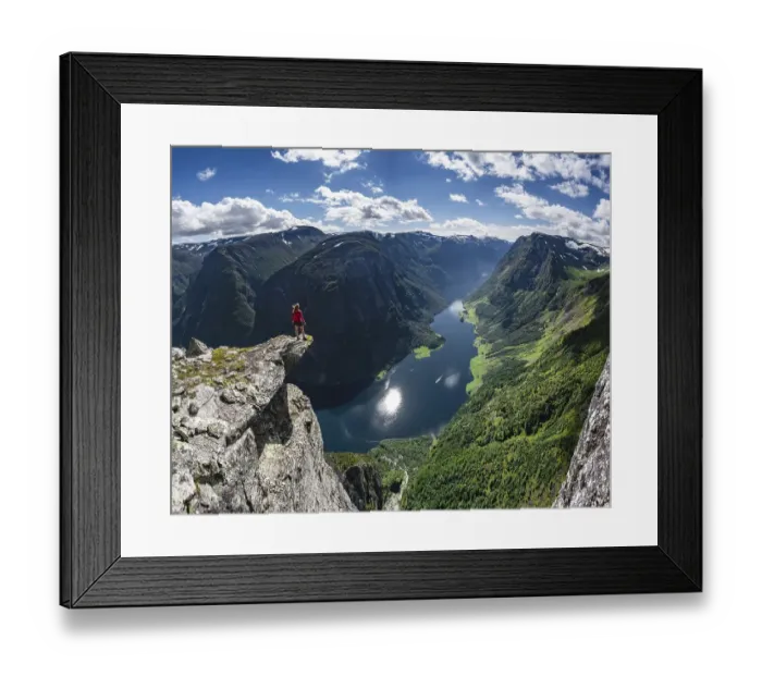 Framed Print : Hiker standing on rocky outcrop