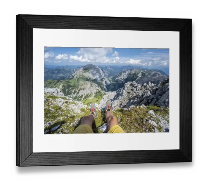 Framed Print : Mountain landscape, hiker lets his legs dangle