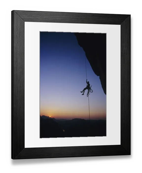 Framed Print : Extreme sport, a man abseiling with a bike in front of the sunset