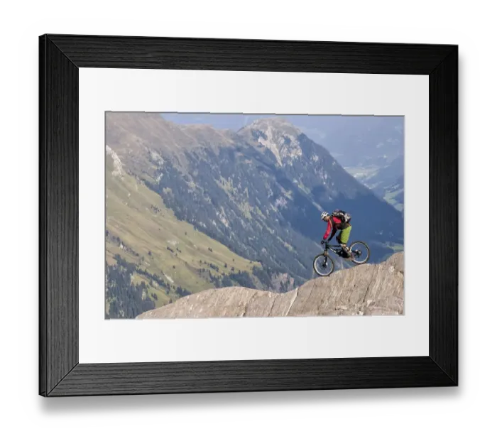 Framed Print : Freeride mountain biker with Liteville riding over cliff edge