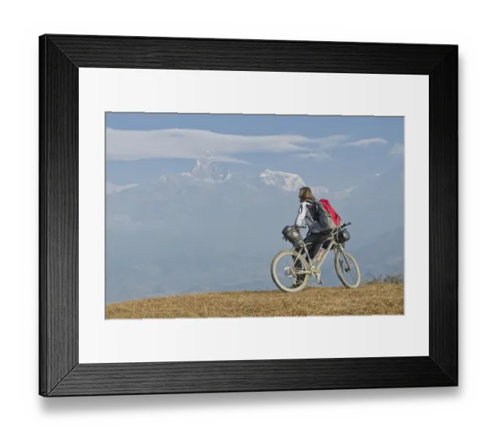 Framed Print : Cyclist leaning on his bike, looking towards Annapurna range
