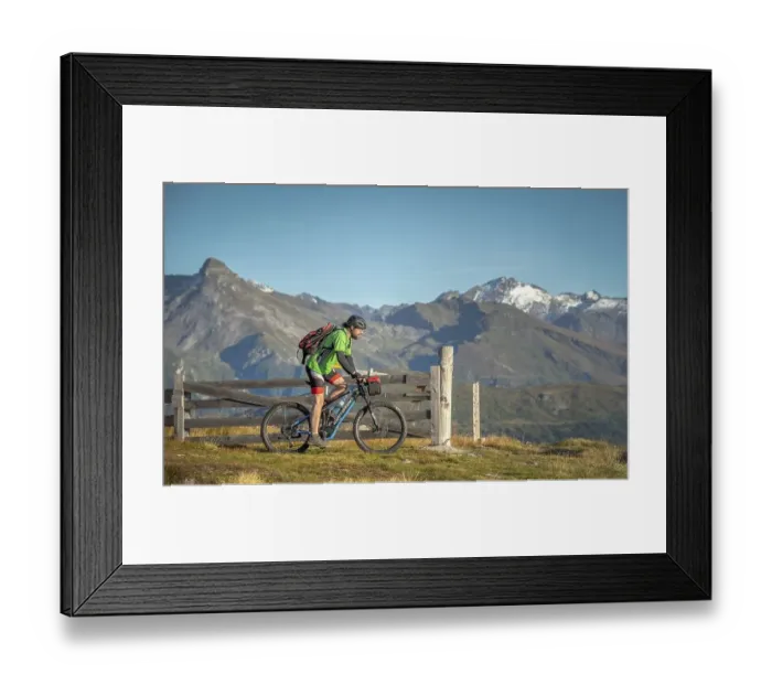 Framed Print : Mountain biker, late 40s, rides eMTB on single trail in the autumnal mountain landscape of the Stubaier Alps