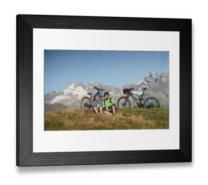 Framed Print : Mountain biker couple sitting next to eBikes in the autumnal mountain scenery of the Stubaier Alps
