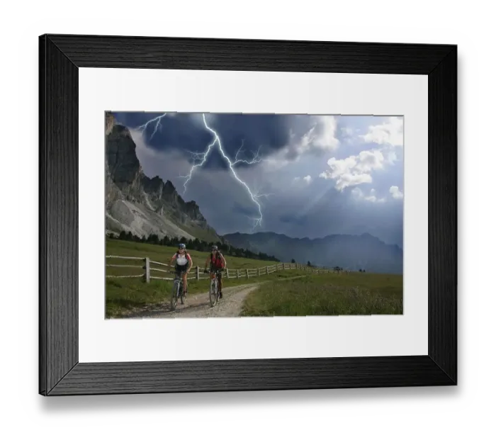 Framed Print : Female mountain bikers during a thunderstorm