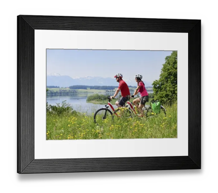 Framed Print : Couple with electric bikes above Lake Wallersee near Weng Framed Print : Couple with electric bikes above Lake Wallersee near Weng
