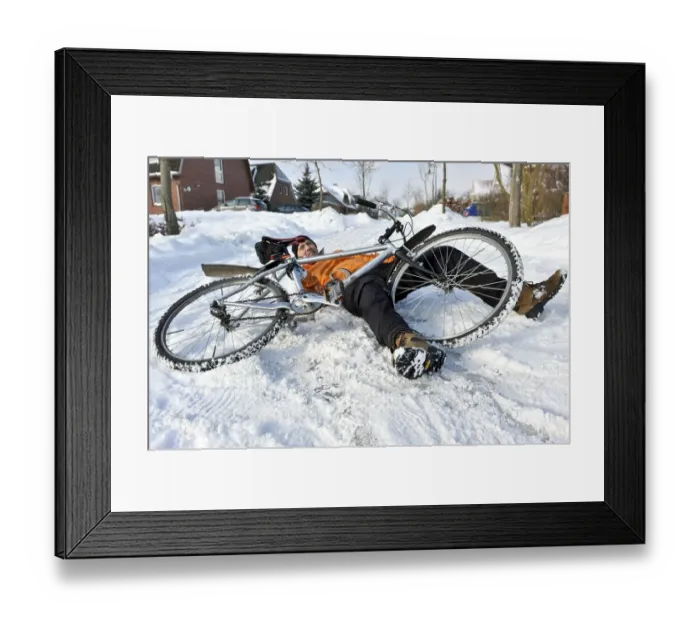 Framed Print : Cyclist crashing on a snow-covered slippery road