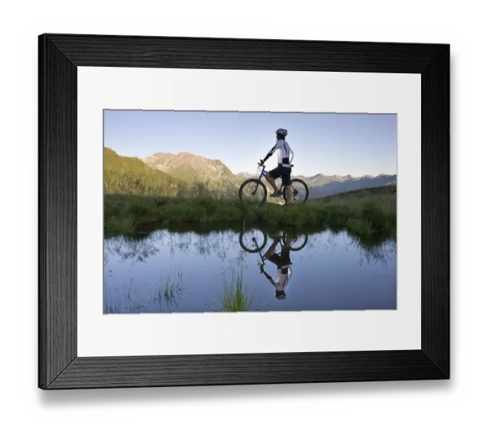 Framed Print : Mountainbiker on the shore of a mountain lake